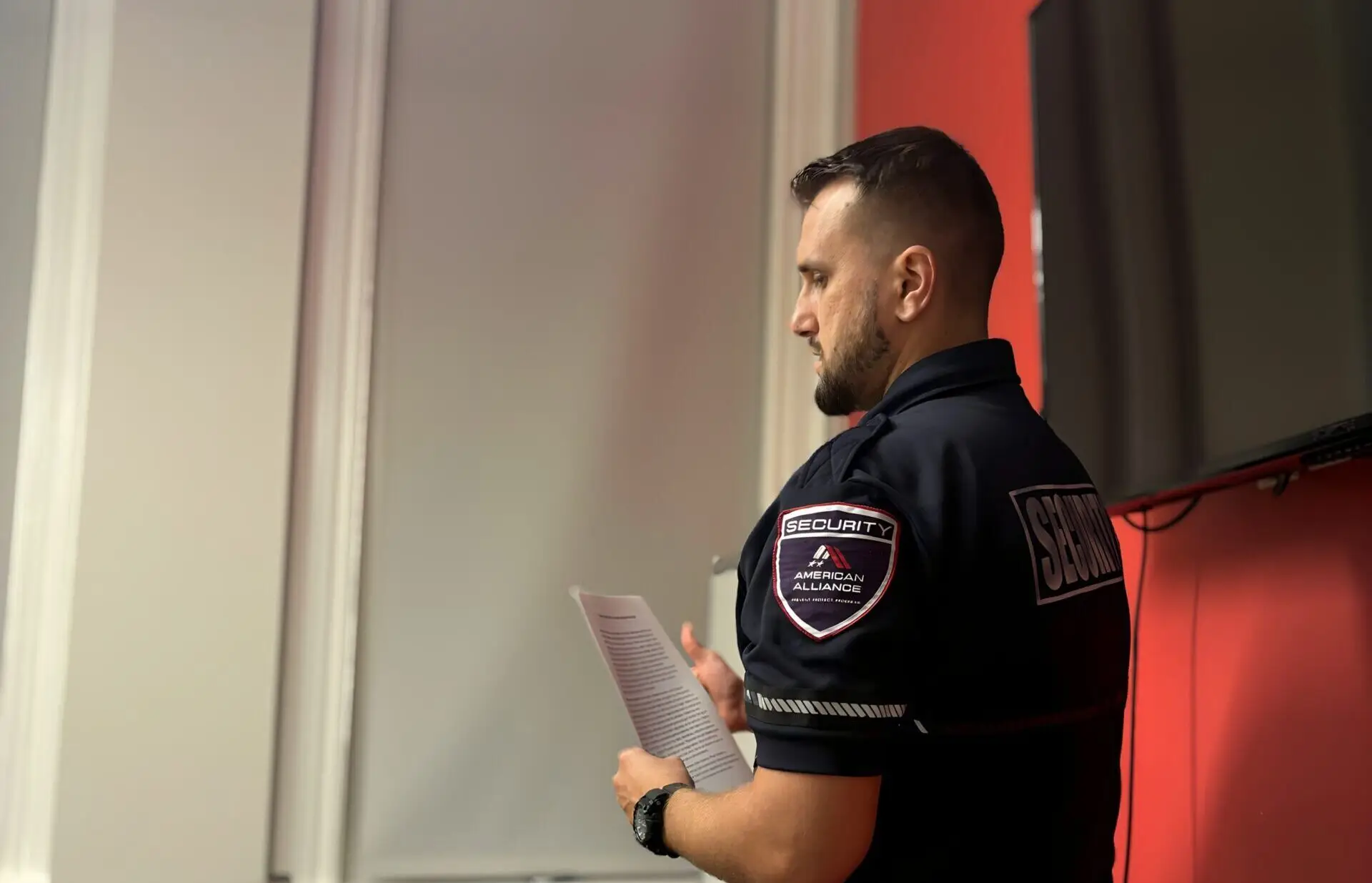 A security officer reading through a printed checklist